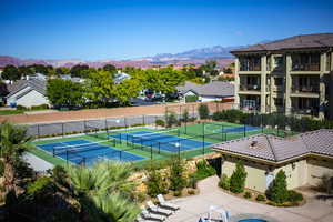 View of tennis court with a mountain view