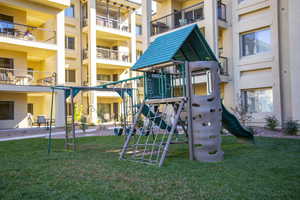 View of jungle gym with a yard