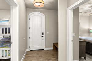 Entrance foyer featuring hardwood / wood-style flooring, ceiling fan, and a textured ceiling