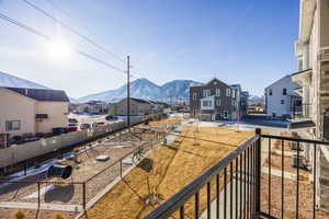 Balcony featuring cooling unit and a mountain view