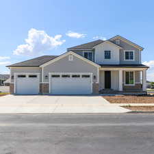 View of front of house featuring a garage and a porch