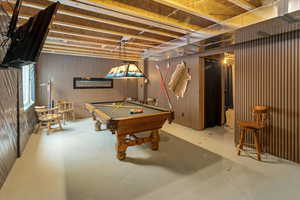 Rec room with pool table and concrete flooring