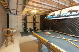 Rec room with billiards and concrete flooring