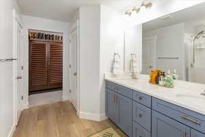 Bathroom featuring hardwood / wood-style flooring and vanity