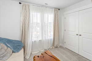 Carpeted bedroom featuring a closet