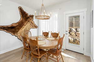 Dining area featuring an inviting chandelier and hardwood / wood-style floors