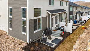 Rear view of property with a mountain view and a patio area