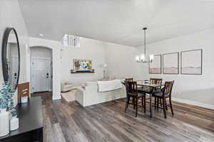 Dining space featuring dark wood-type flooring and a chandelier