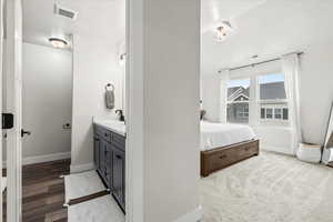 Bedroom featuring sink and light hardwood / wood-style floors