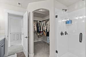 Bathroom featuring vanity and an enclosed shower