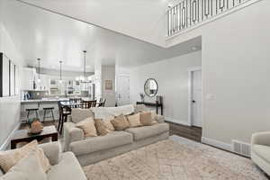 Living room with hardwood / wood-style floors and an inviting chandelier