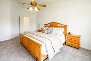 Bedroom with ceiling fan and light colored carpet