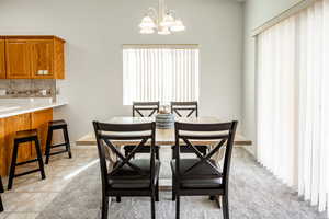 Tiled dining space with an inviting chandelier