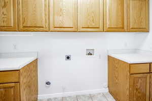 Laundry room featuring washer hookup, electric dryer hookup, cabinets, and gas dryer hookup