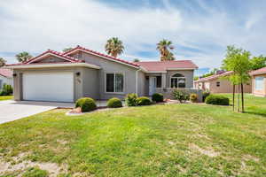 View of front facade with a garage and a front lawn