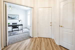 Hall featuring light wood-type flooring