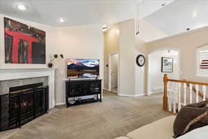 Carpeted living room with vaulted ceiling