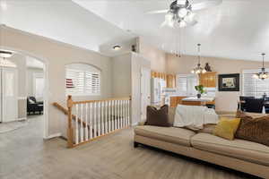 Living room featuring lofted ceiling, light colored carpet and a textured ceiling