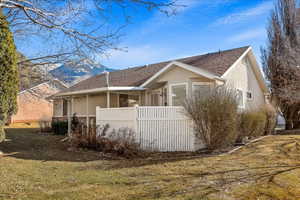 View of property exterior featuring a yard and a mountain view