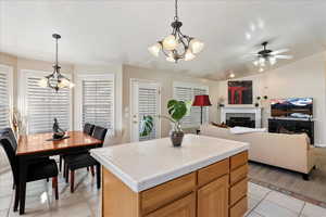 Kitchen featuring hanging light fixtures, tile counters, plenty of natural light, and a kitchen island