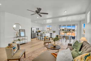 Living area with light wood-style flooring, recessed lighting, and ceiling fan