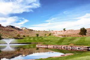 View of community featuring view of golf course and a water and mountain view