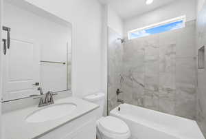 Full bathroom featuring toilet, shower / washtub combination, and vanity