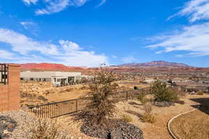 View of yard featuring fence and a mountain view