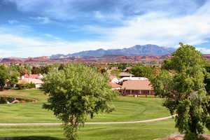 View of community with a mountain view, golf course view, and a yard