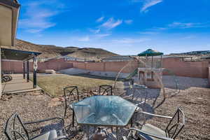 View of patio / terrace featuring a playground and a mountain view