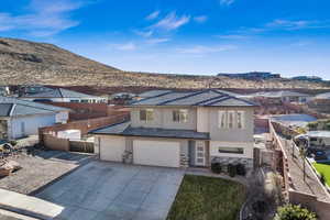 View of front of house with a garage and a mountain view