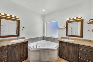 Bathroom with vanity and a relaxing tiled tub