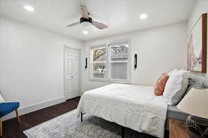 Bedroom with wood-style floors, ceiling fan, and a closet