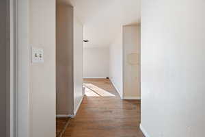 Hallway with light hardwood / wood-style floors