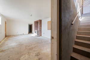 Unfurnished living room featuring heating unit