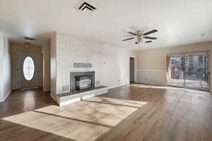 Unfurnished living room featuring dark hardwood / wood-style floors and ceiling fan