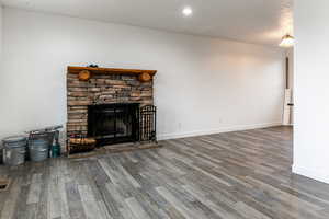 Unfurnished living room with hardwood / wood-style flooring and a fireplace