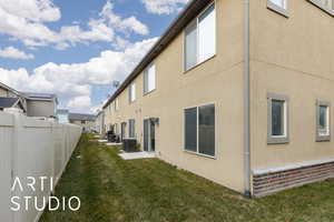 View of property exterior featuring a yard and central air condition unit