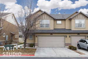 Townhome / multi-family property featuring a garage