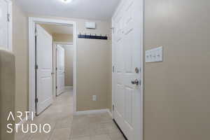 Hall featuring light tile patterned floors