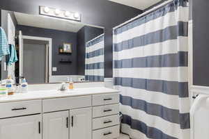 Bathroom featuring vanity, a textured ceiling, and walk in shower