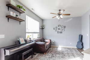 Sitting room with hardwood / wood-style flooring and ceiling fan