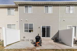 Back of property with a patio and central AC