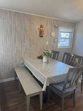 Dining area featuring dark hardwood / wood-style flooring and a textured ceiling