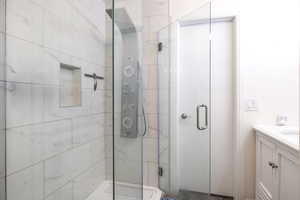 Bathroom with vanity and a shower with door