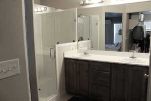 Primary bathroom with an enclosed shower and vanity