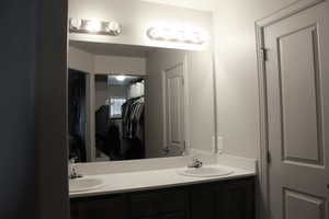 Primary bathroom with vanity, and double sink