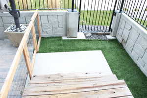 Back patio, with turf , pavers, and fencing