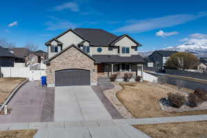 View of front of home featuring a mountain view, a garage, and covered porch