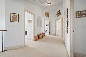 Hall featuring light colored carpet